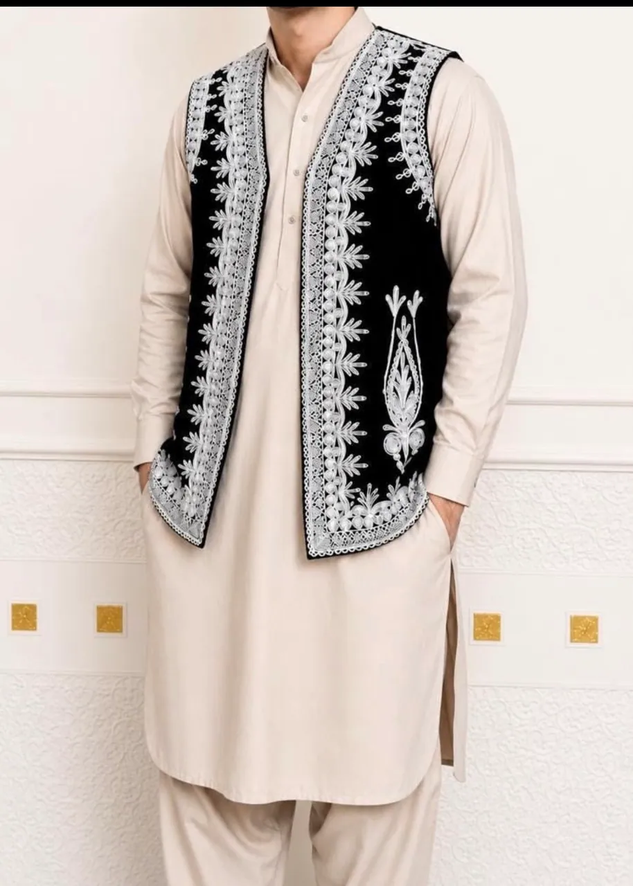 Man wearing a beige shalwar kameez with a black embroidered waistcoat