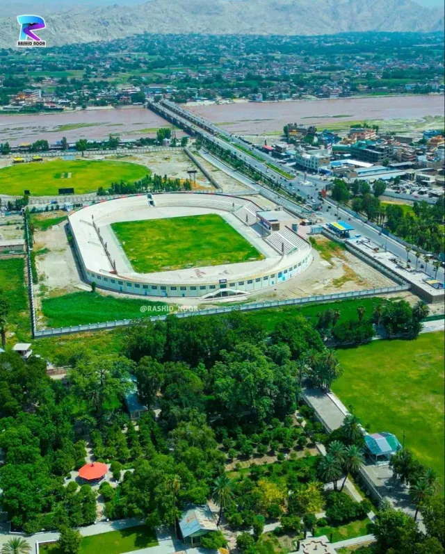 Aerial view of Jalalabad, with its stadium among green fields and trees